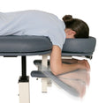 Patient model with blue Lifetimer International Table option accessory ergonomic pivoting arm rests for portable and elevation chiropractic, massage and physical therapy tables